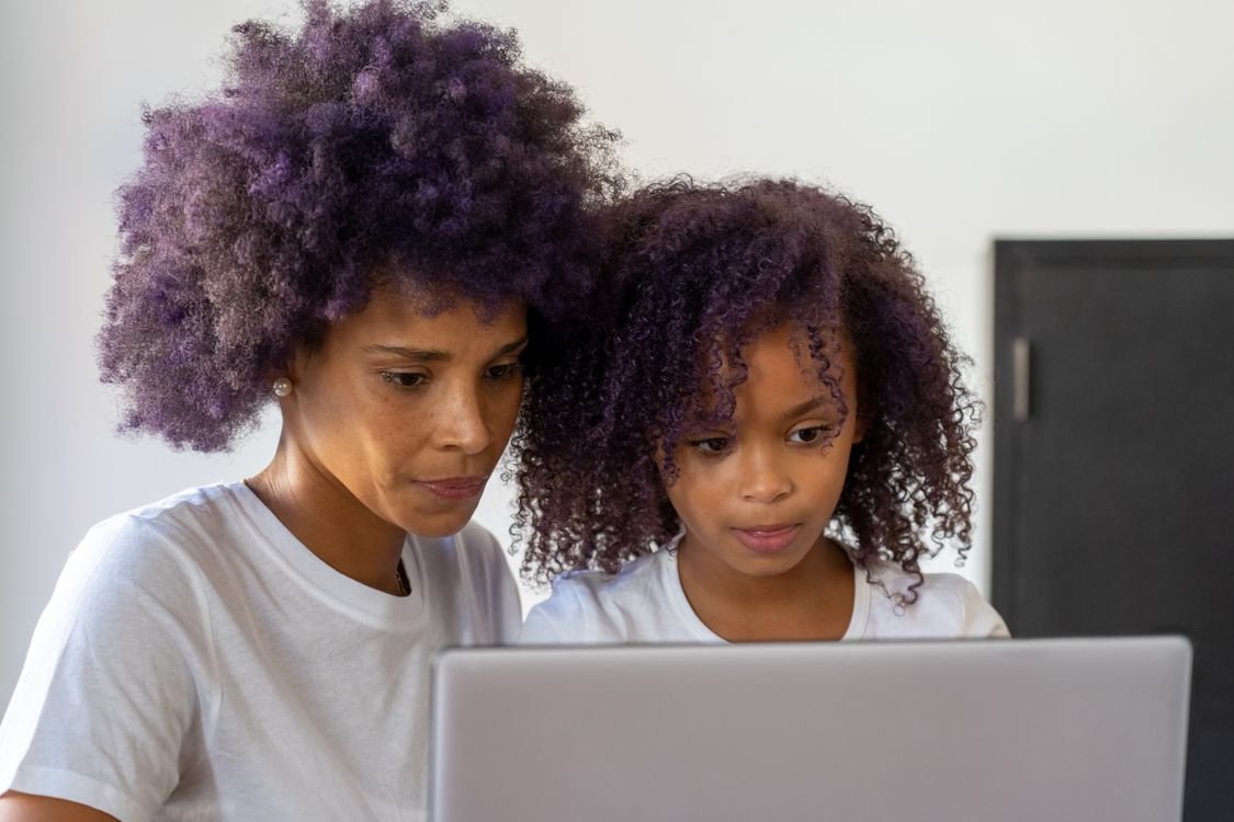 A mother and daughter learning together on a laptop